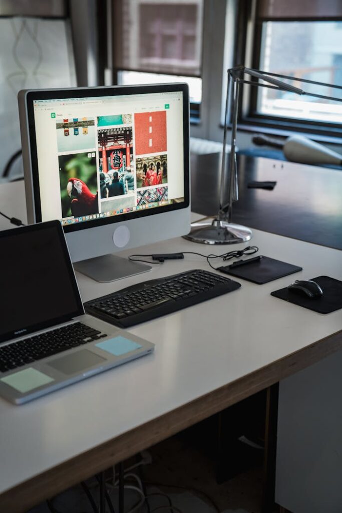 A sleek, modern office desk setup with computers and gadgets, perfect for productivity.